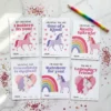 Flat lay of 6 printable unicorn valentine cards for kids arranged on marble with rainbow pencil and heart confetti.