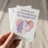 Hand holding a small 2.75 x 3.75 inch unicorn valentine card next to a white mini envelope.