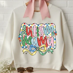 Autism Mama PNG design on cream sweatshirt with coquette pink bow