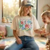 Happy mom wearing Autism Mama t-shirt in a sunlit playroom with child