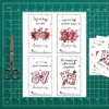 Printed sheet of 4 Valentine cards on a green cutting mat with scissors, showing dotted cut lines for easy DIY preparation.