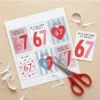 Cutting out printable valentine cards with scissors DIY craft activity for kids and parents.