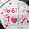 Flat lay of 6 funny printable 67 slang Valentine's Day cards with candy hearts for kids classroom exchange.