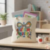Aesthetic tote bag with autism awareness bow design on a teacher's desk in a classroom setting.