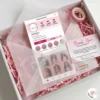 Cute small business packaging idea with pink crinkle paper, vellum envelope, and Instagram business card inside a white box.