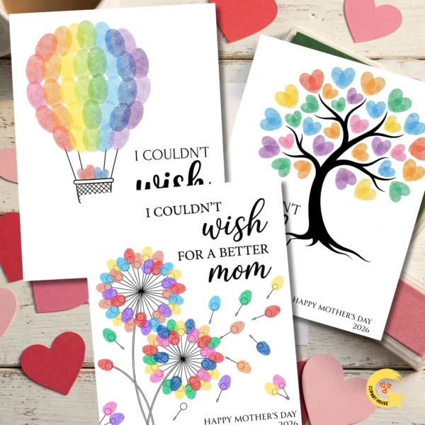 A creative flat lay showing three Mother's Day cards (Balloon, Tree, Dandelion) fanned out on a white wooden table with heart confetti and green ink pads.