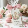 Floral bunny thank you for hopping by tag attached to a clear cellophane treat bag filled with pink macarons.