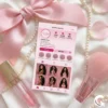 Coquette aesthetic flat lay with pink business card, satin bow, pearl necklace, lip gloss, and makeup brush for beauty influencers.