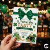 Hand holding a printed St. Patrick's Day invitation in a blurry pub background with green balloons and beer glasses.