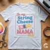 Printed sublimation transfer paper with String Cheese Mama Era design resting on an ash grey t-shirt next to crafting scissors and heat tape.